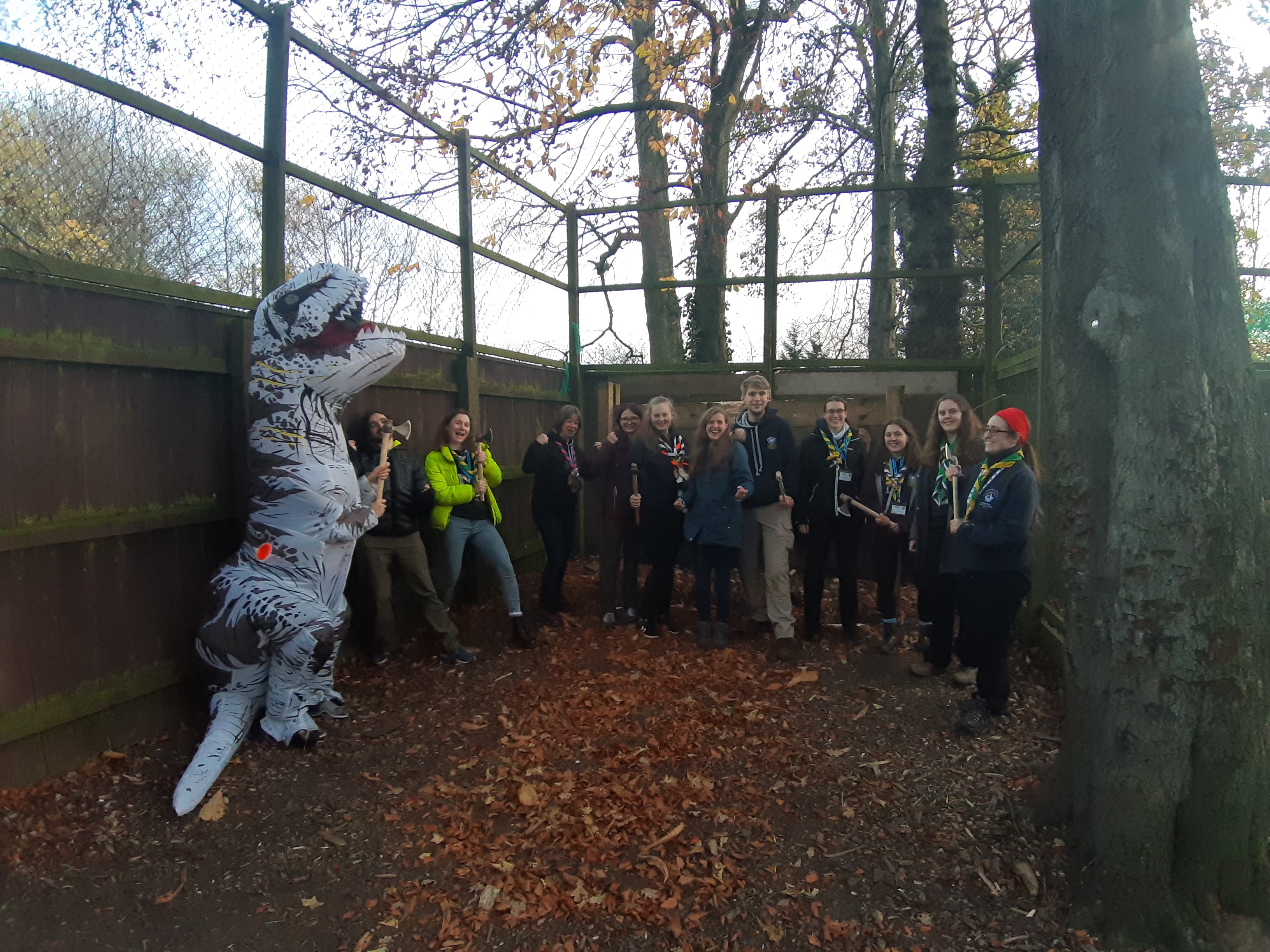 Small group photo from those doing the Viking Weapons Training activity, stood in a range, with an inflatable dinosaur also present